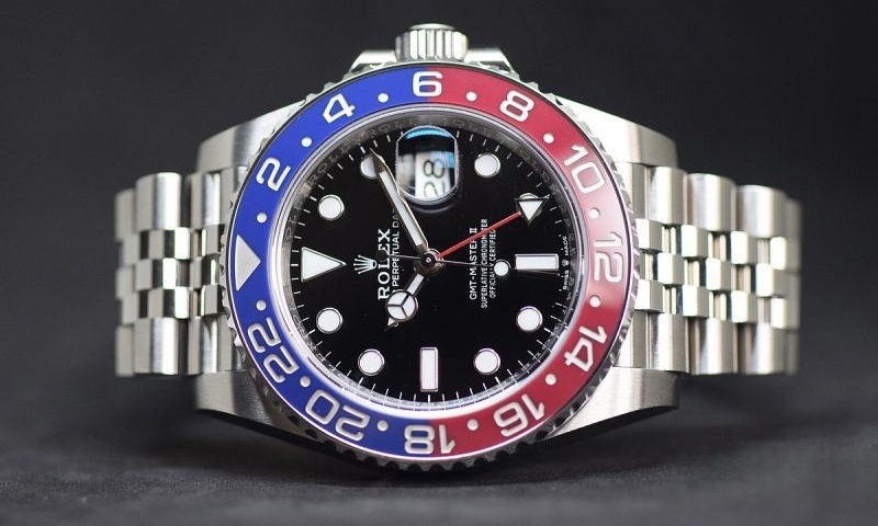 Close-up of Rolex GMT-Master II Pepsi Cerachrom bezel on a super clone watch, showcasing the red and blue two-tone ceramic finish