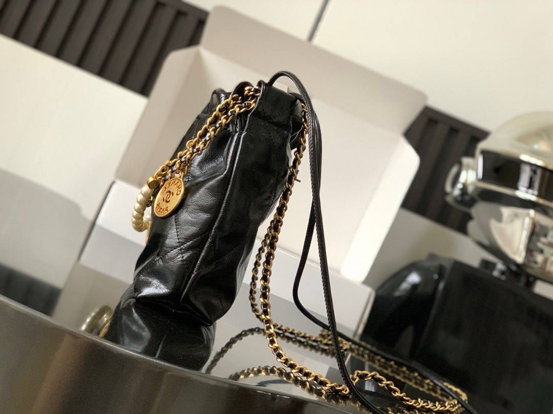 CHANEL CHANEL 22 Mini Handbag Shiny Calfskin, Imitation Pearls & Gold-Tone Metal Black- AS3980