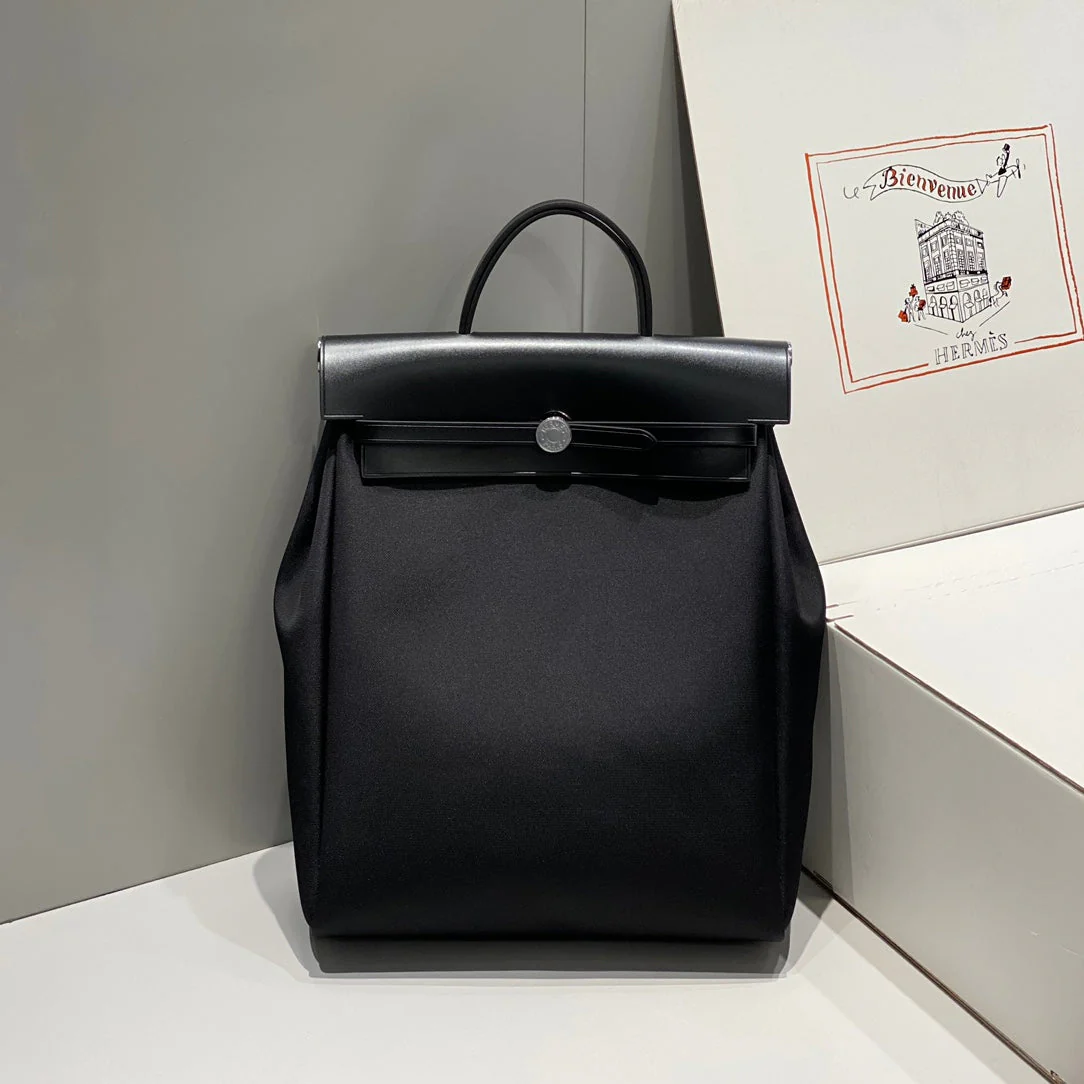 HERBAG A DOS ZIP RETOURNE BACKPACK 29 IN BLACK CANVAS AND CALFSKIN