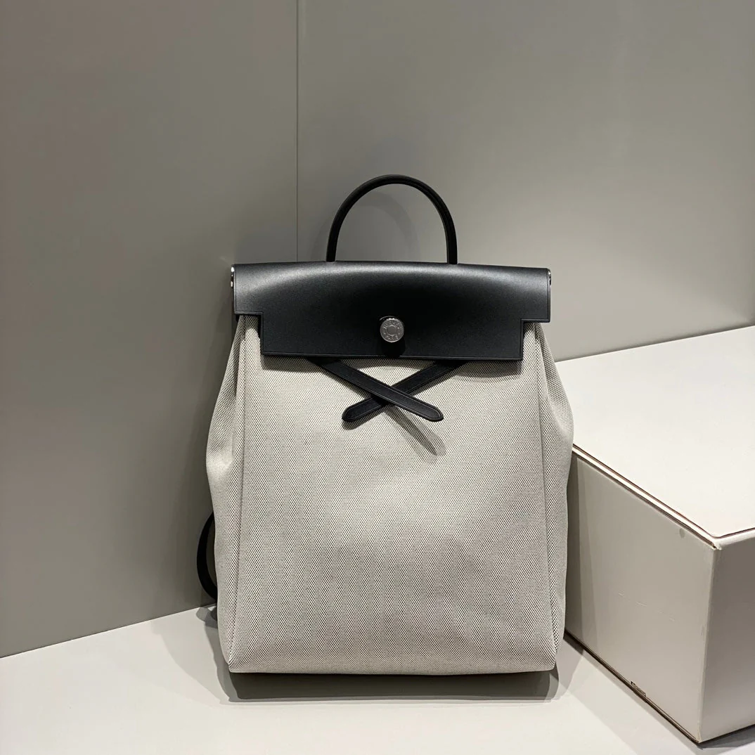HERBAG A DOS ZIP RETOURNE BACKPACK 29 IN OFF-WHITE CANVAS AND BLACK CALFSKIN