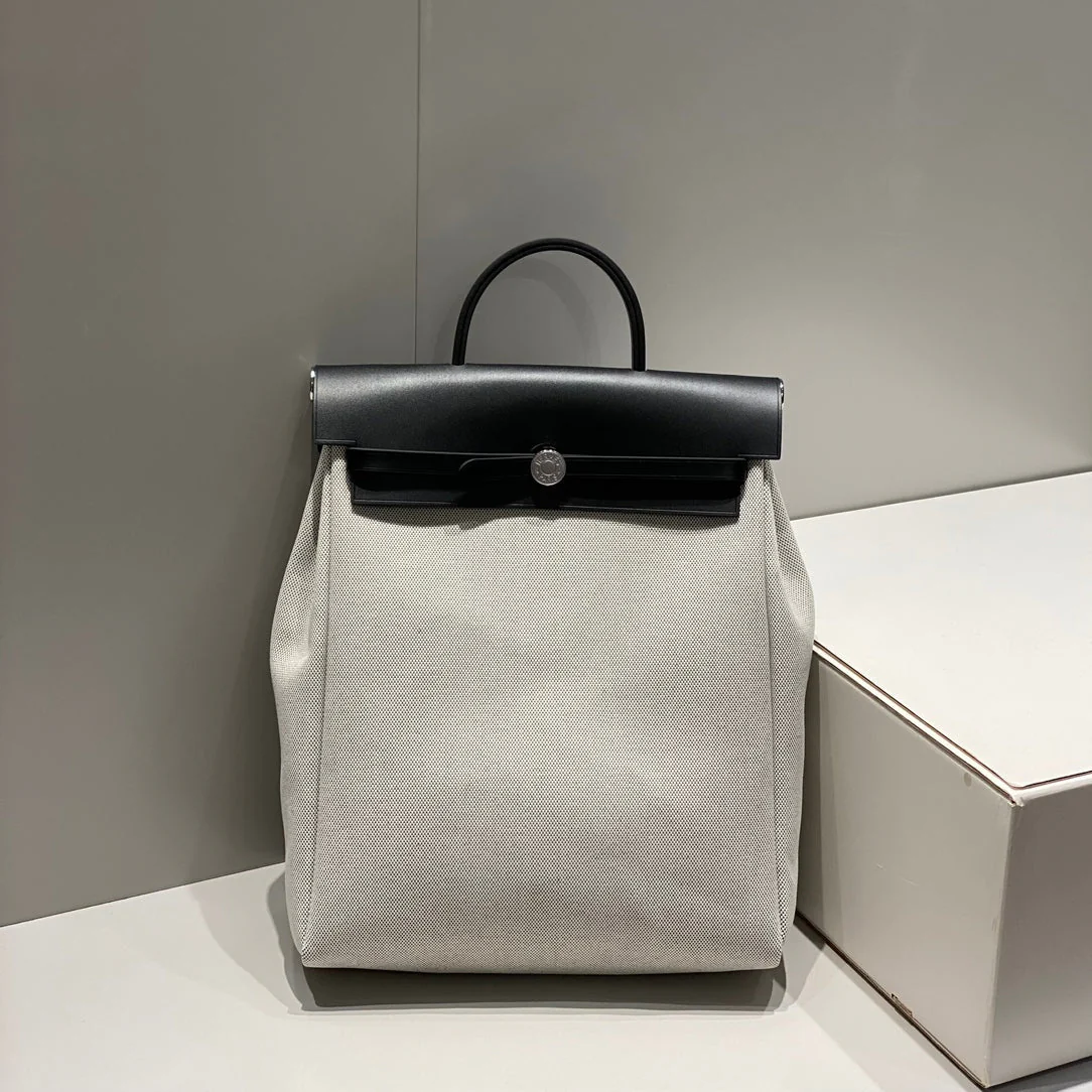 HERBAG A DOS ZIP RETOURNE BACKPACK 29 IN OFF-WHITE CANVAS AND BLACK CALFSKIN
