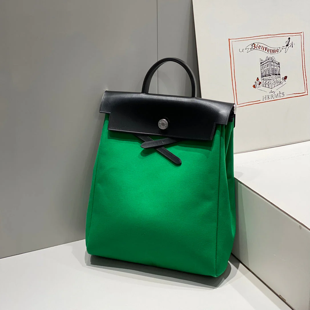 HERBAG A DOS ZIP RETOURNE BACKPACK 29 IN GREEN CANVAS AND BLACK CALFSKIN