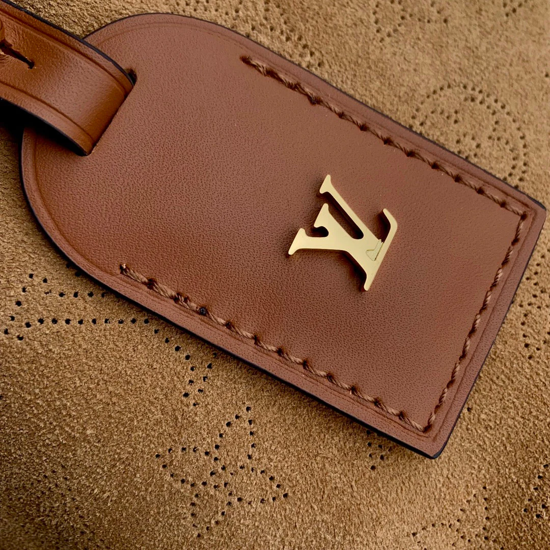 CARRYALL PM 29 IN CIDER BROWN MONOGRAM PERFORATED SUEDE AND WHITE SHEARLING TRIM
