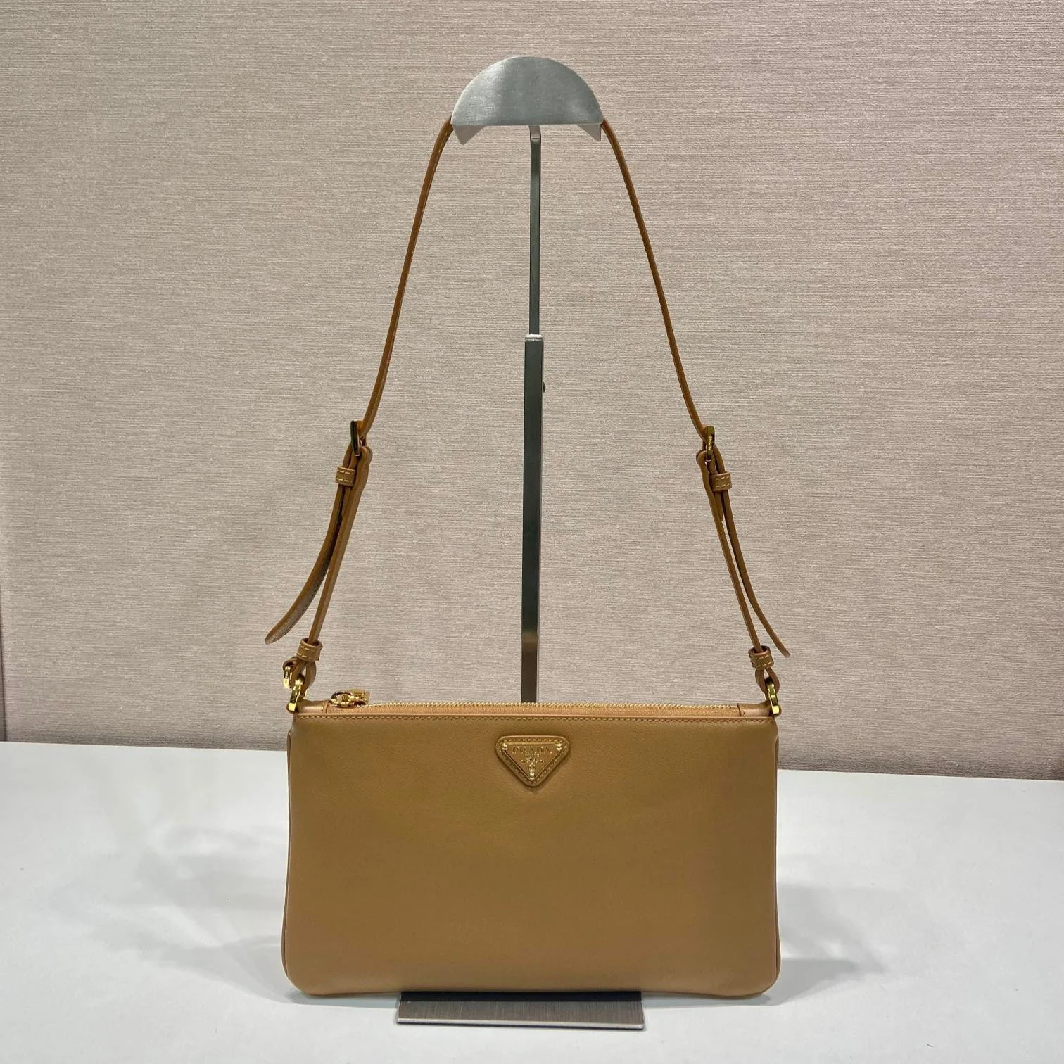 TRIANGLE LOGO SHOULDER BAG 24 IN PEANUT BROWN SMOOTH CALFSKIN