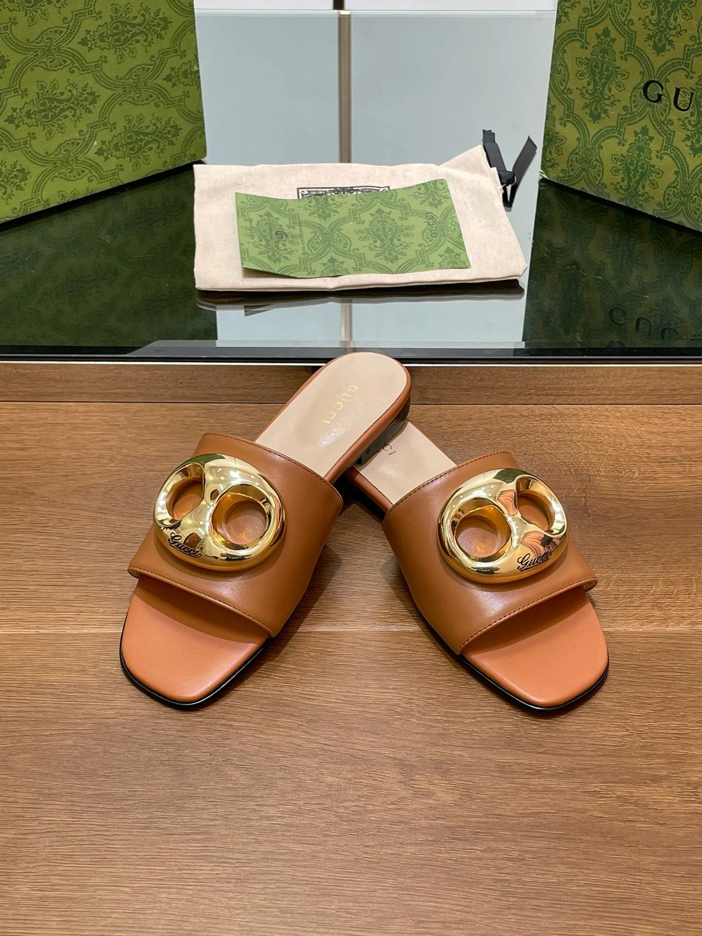 FLAT MULE IN BRONE BROWN CALFSKIN WITH GOLD HARDWARE