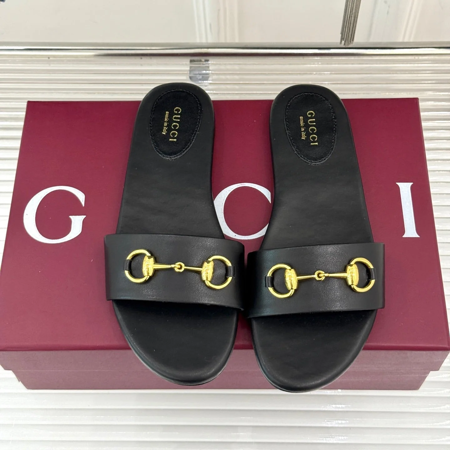 SLIDE SANDALS IN BLACK CALFSKIN WITH GOLD HARDWARE