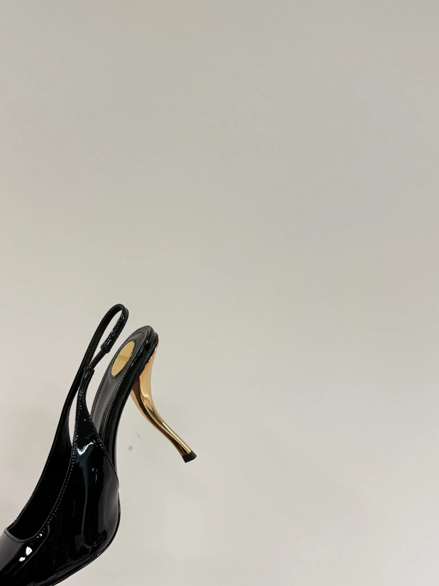 GREEN GEM-STUDDED SLINGBACK PUMPS IN BLACK PATENT CALFSKIN