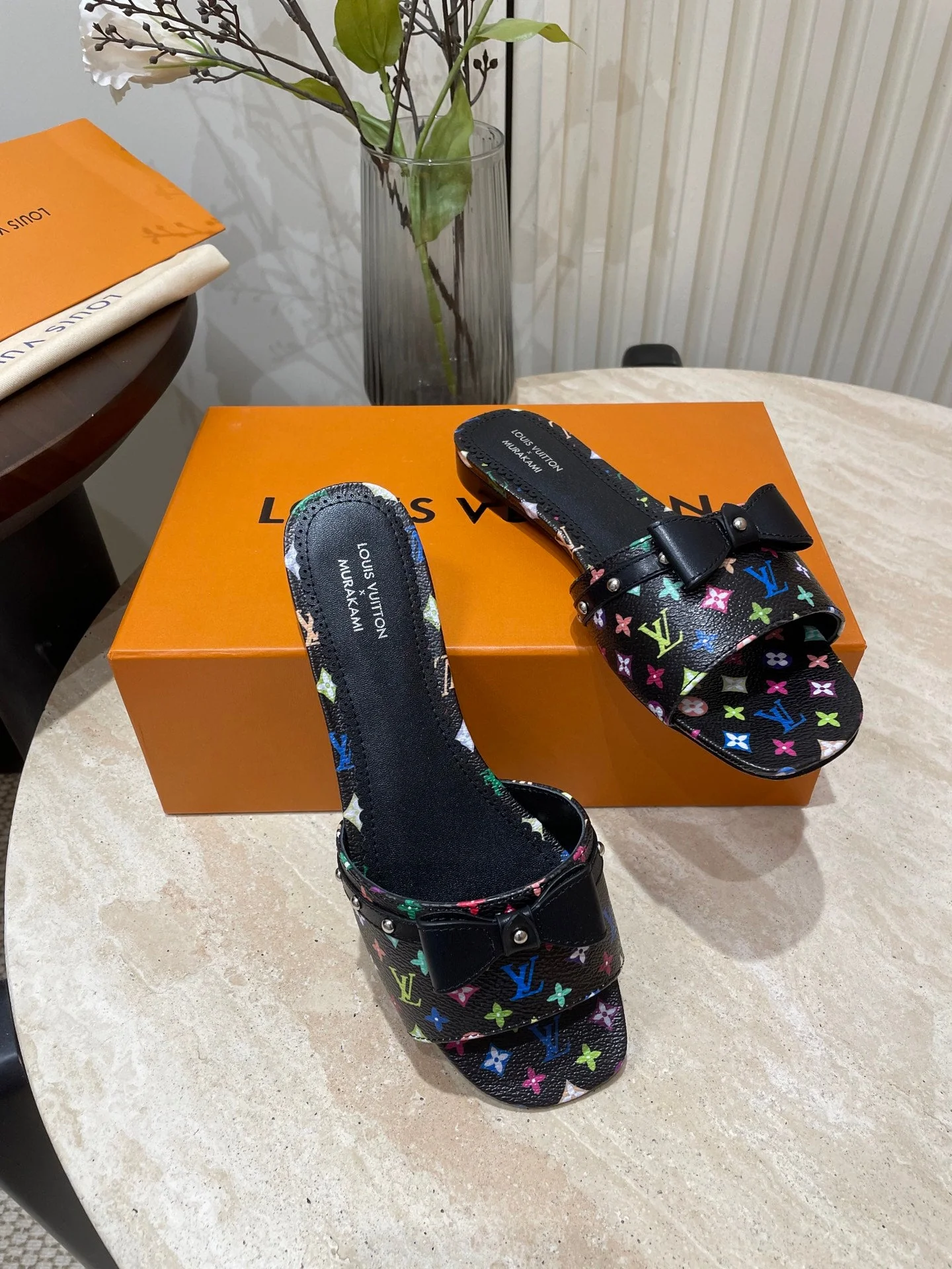 BOW FLAT MULES IN BLACK MONOGRAM LAMBSKIN
