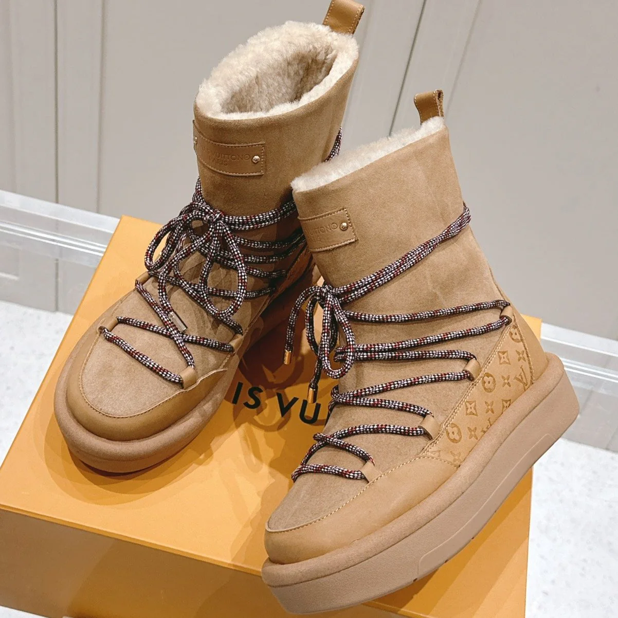 ASPEN PLATFORM ANKLE BOOT IN CIDER BROWN MONOGRAM DEBOSSED SUEDE AND SHEARLING